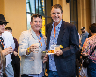 Two men with drinks in their hands